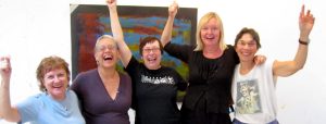 women in intuitive painting workshop celebrating